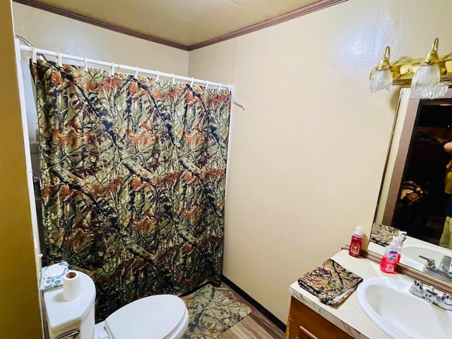 bathroom with wood-type flooring, toilet, vanity, and ornamental molding