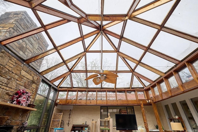 unfurnished sunroom featuring vaulted ceiling and ceiling fan