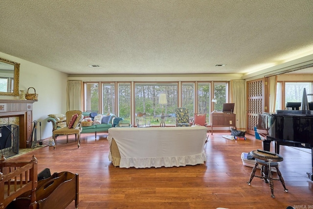 living room featuring hardwood / wood-style flooring, plenty of natural light, and a textured ceiling