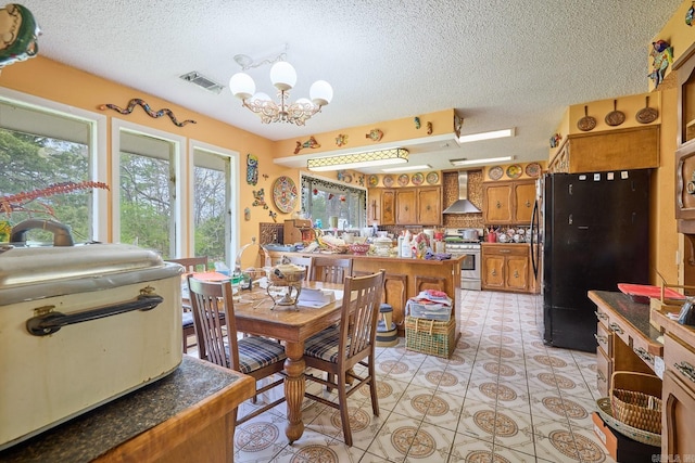 dining area featuring light tile patterned floors, a chandelier, and a textured ceiling