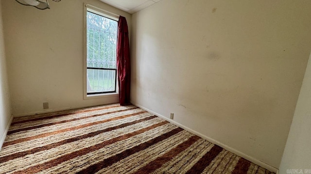 unfurnished room featuring light carpet and plenty of natural light