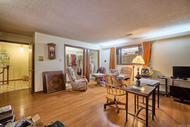 office featuring a wealth of natural light, hardwood / wood-style floors, and a textured ceiling