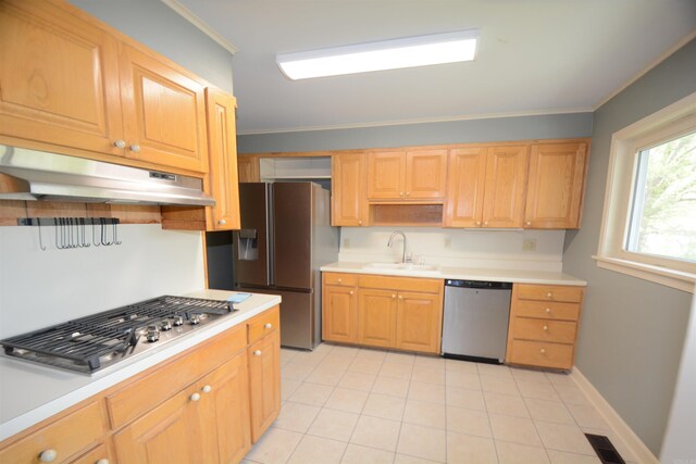 kitchen featuring ornamental molding, light tile floors, appliances with stainless steel finishes, and sink