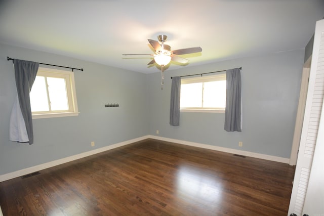 spare room featuring ceiling fan and dark hardwood / wood-style flooring