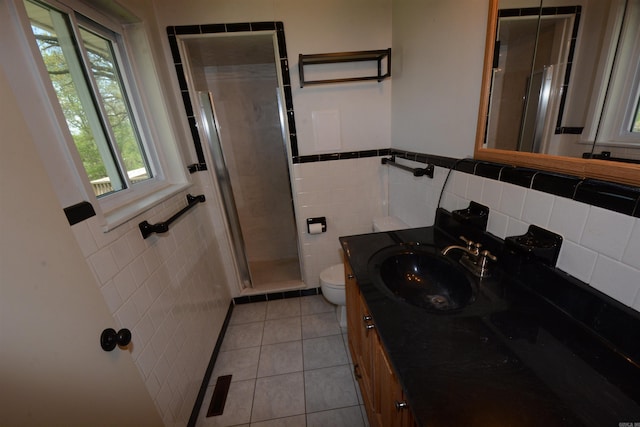 bathroom with walk in shower, tile walls, tile flooring, toilet, and oversized vanity