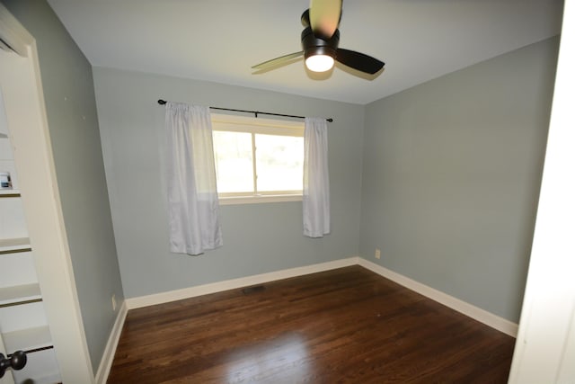 unfurnished room featuring dark hardwood / wood-style floors and ceiling fan