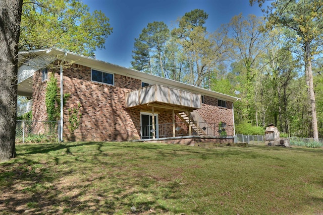 rear view of property featuring a lawn