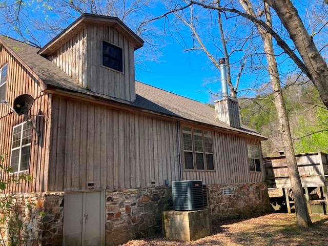 view of side of home featuring central air condition unit