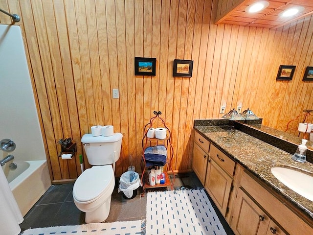 full bathroom with tile flooring, vanity, and wooden walls