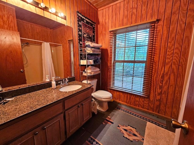 bathroom featuring vanity with extensive cabinet space, wood walls, tile flooring, wood ceiling, and toilet