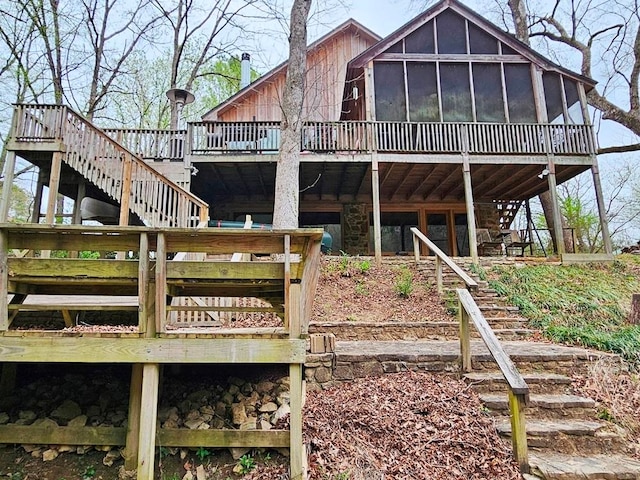 back of house featuring a wooden deck and a sunroom