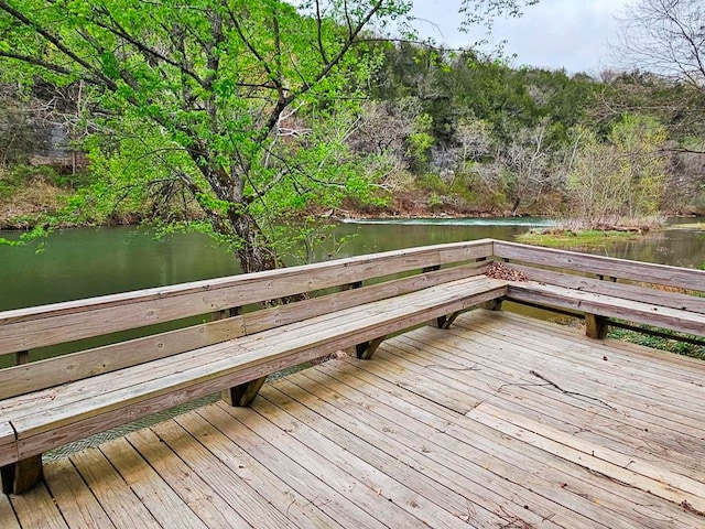 wooden terrace featuring a water view