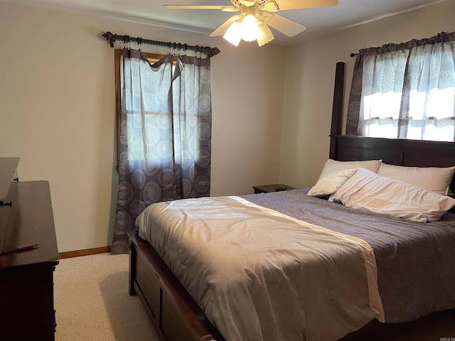 bedroom featuring ceiling fan and carpet