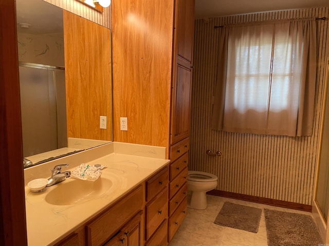 bathroom featuring tile flooring, oversized vanity, and toilet