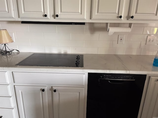 kitchen with backsplash, white cabinets, and dishwasher