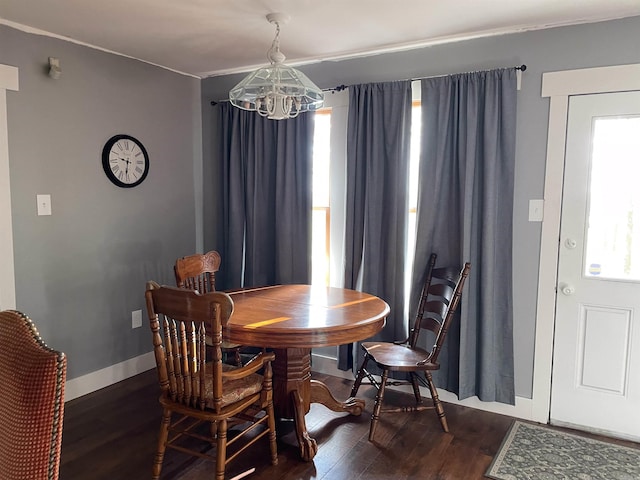 dining room with a chandelier and dark hardwood / wood-style flooring