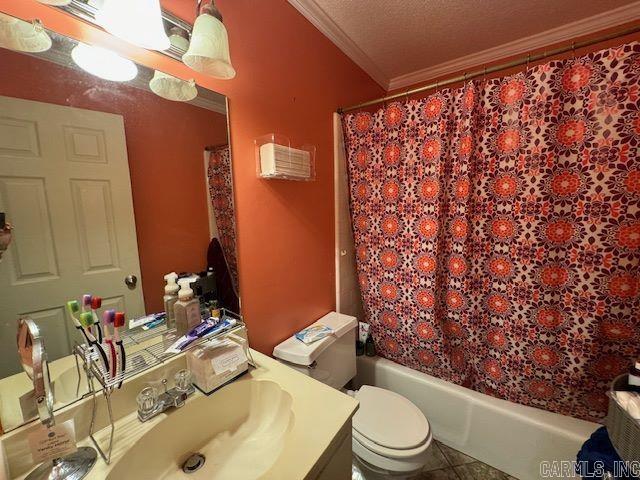 full bathroom featuring vanity, shower / bathtub combination with curtain, a textured ceiling, toilet, and crown molding