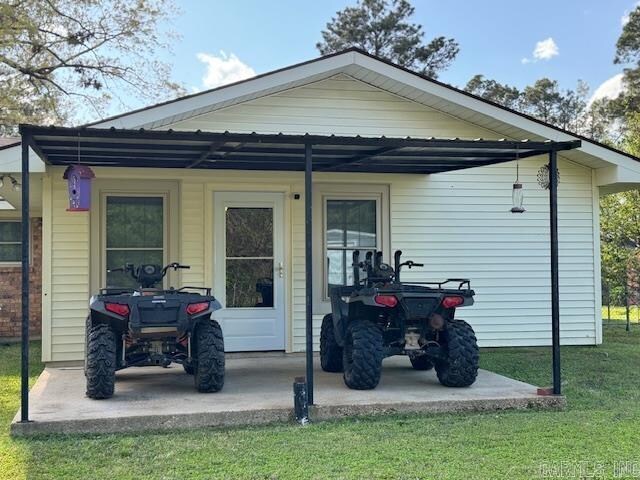 back of property featuring a lawn