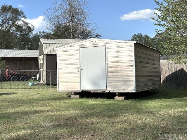 view of outdoor structure featuring a lawn