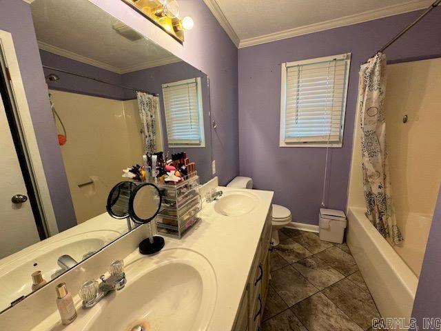 full bathroom featuring double sink vanity, toilet, shower / bath combo, ornamental molding, and tile floors