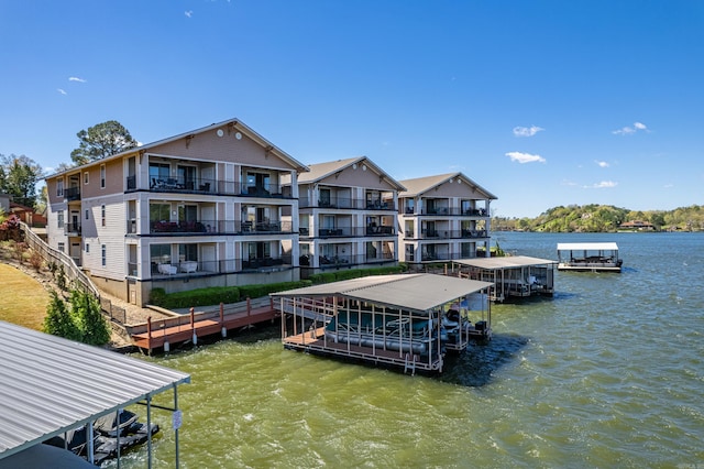 view of dock featuring a balcony and a water view