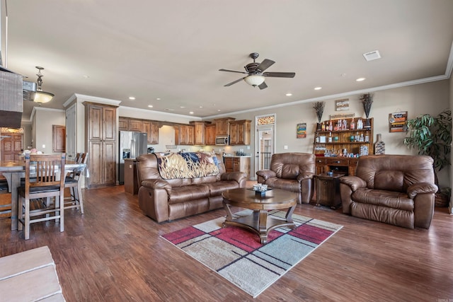 living room featuring ornamental molding, ceiling fan, and dark wood-type flooring