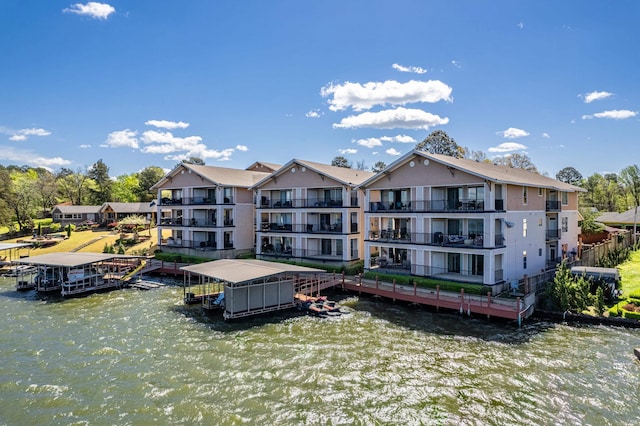 back of house with a balcony and a water view