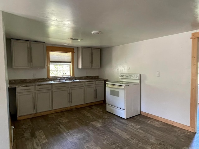 kitchen with gray cabinetry, dark hardwood / wood-style floors, white electric range oven, and sink