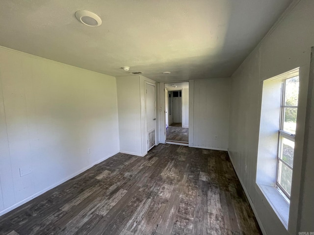 empty room with dark hardwood / wood-style floors