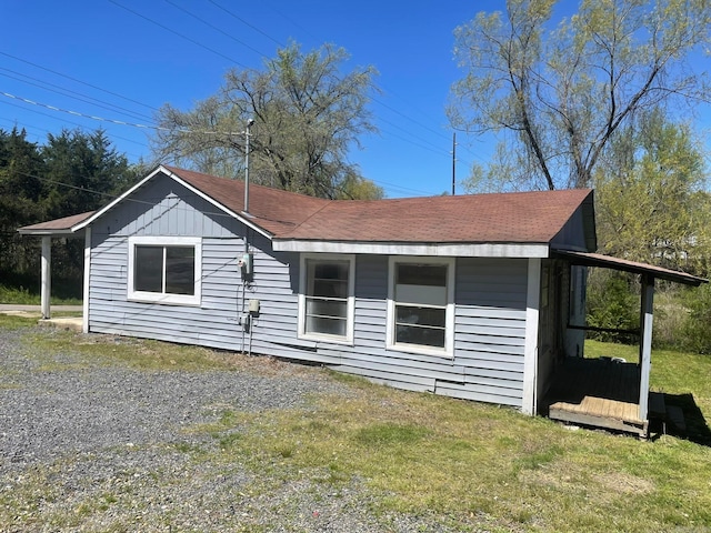 rear view of house featuring a yard