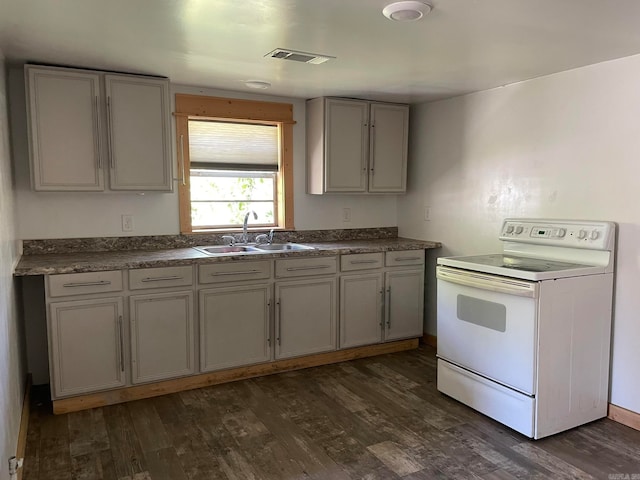 kitchen with gray cabinetry, dark wood-type flooring, electric range, and sink