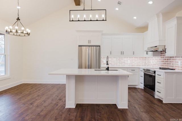 kitchen featuring white cabinets, appliances with stainless steel finishes, vaulted ceiling with beams, and dark hardwood / wood-style flooring