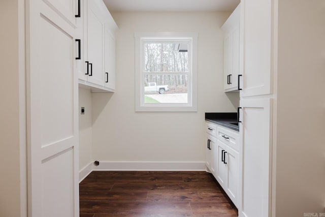 washroom featuring electric dryer hookup and dark hardwood / wood-style floors