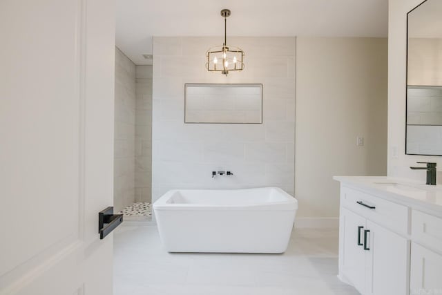 bathroom with vanity, plus walk in shower, and a chandelier