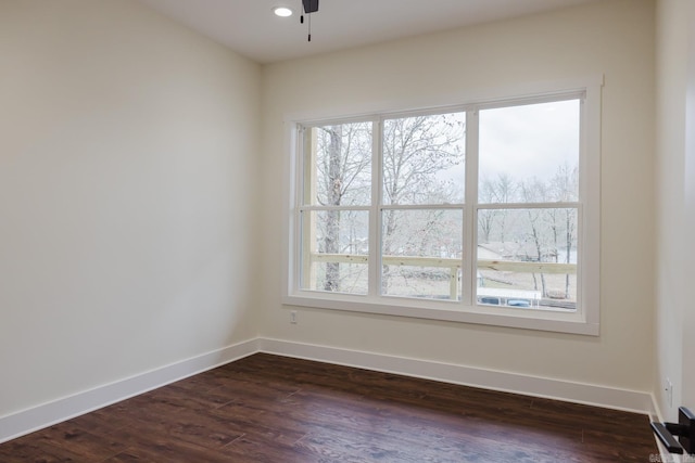 spare room with ceiling fan and dark hardwood / wood-style flooring