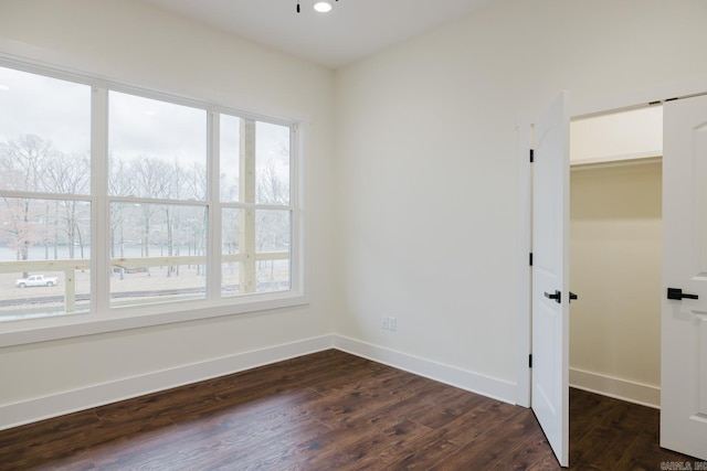 empty room featuring dark wood-type flooring