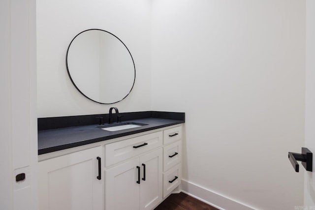 bathroom featuring hardwood / wood-style flooring and vanity