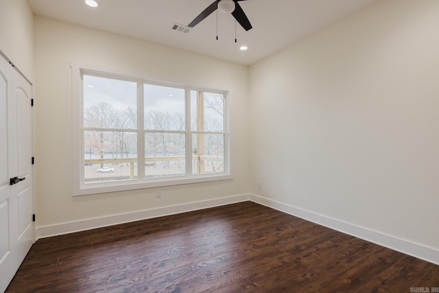 unfurnished room with ceiling fan and dark hardwood / wood-style flooring