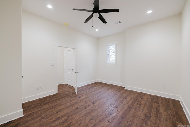 unfurnished room featuring ceiling fan and dark wood-type flooring