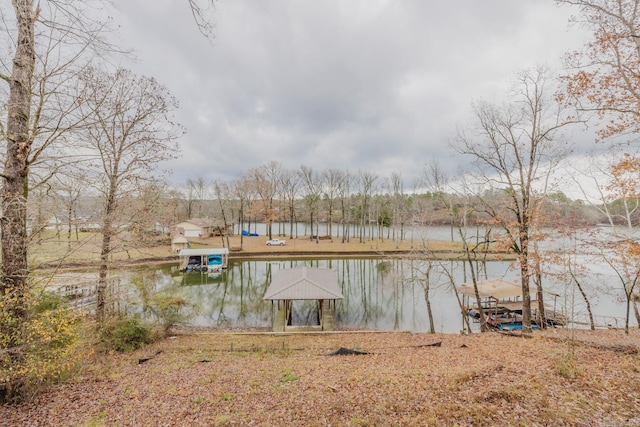 view of dock with a gazebo and a water view