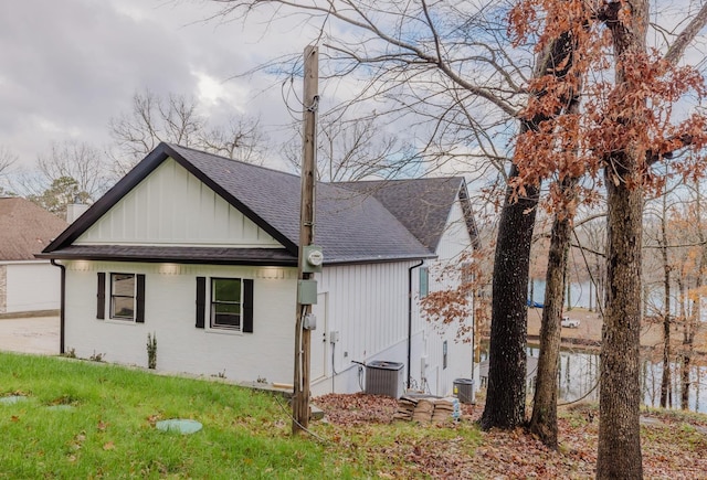 view of home's exterior with central AC unit and a yard