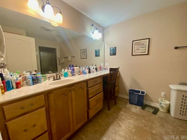 500 E Ingram St, E Camden, AR 71701 - bathroom with tile patterned flooring, vanity, and baseboards