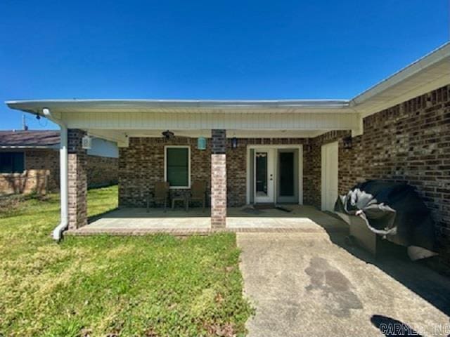 500 E Ingram St, E Camden, AR 71701 - entrance to property featuring brick siding, a yard, and a patio