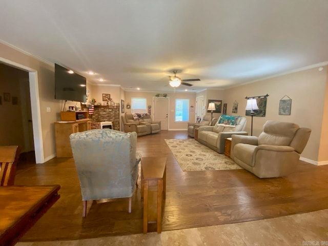 500 E Ingram St, E Camden, AR 71701 - living room with crown molding, baseboards, ceiling fan, a brick fireplace, and wood finished floors
