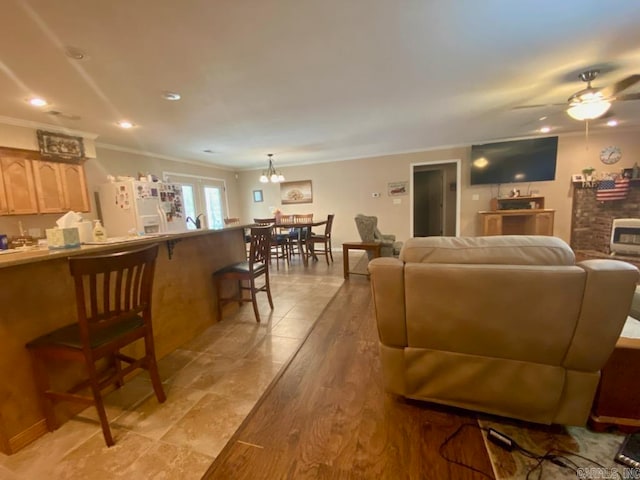 500 E Ingram St, E Camden, AR 71701 - living room featuring a brick fireplace, recessed lighting, ornamental molding, ceiling fan with notable chandelier, and light wood-style flooring