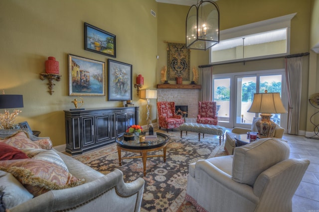 tiled living room featuring a notable chandelier and a towering ceiling