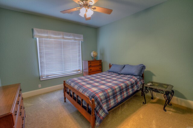 bedroom with light carpet and ceiling fan