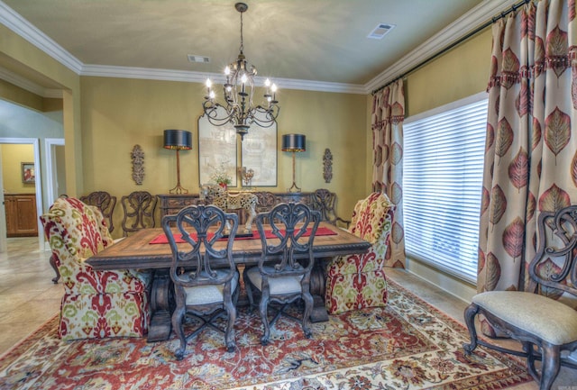 tiled dining space featuring ornamental molding and an inviting chandelier