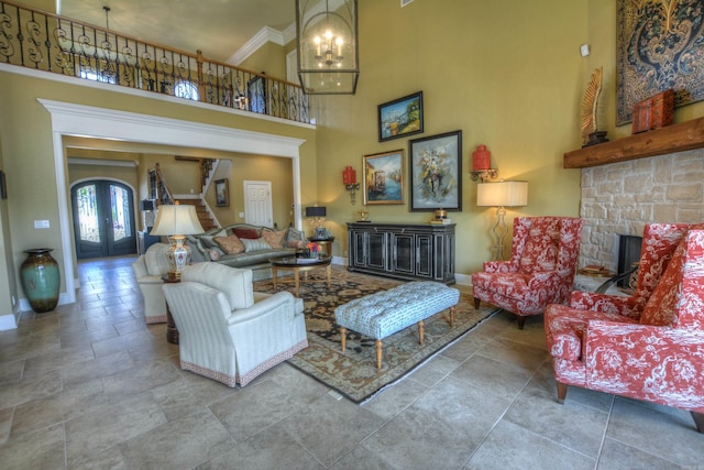 living room featuring french doors, light tile flooring, a fireplace, and a high ceiling