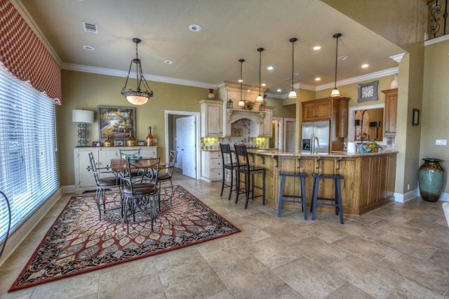 kitchen with light tile floors, a kitchen bar, kitchen peninsula, stainless steel fridge with ice dispenser, and hanging light fixtures